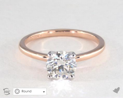a thin rose gold band with a round diamond.
