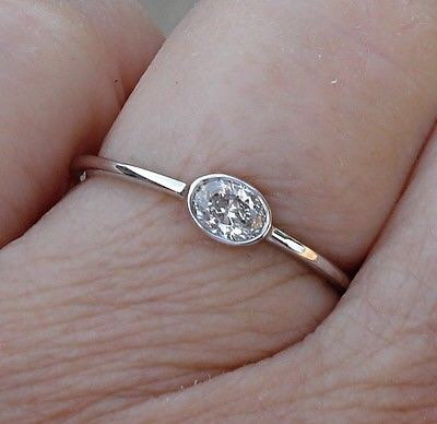 oval bezel east-west engagement ring